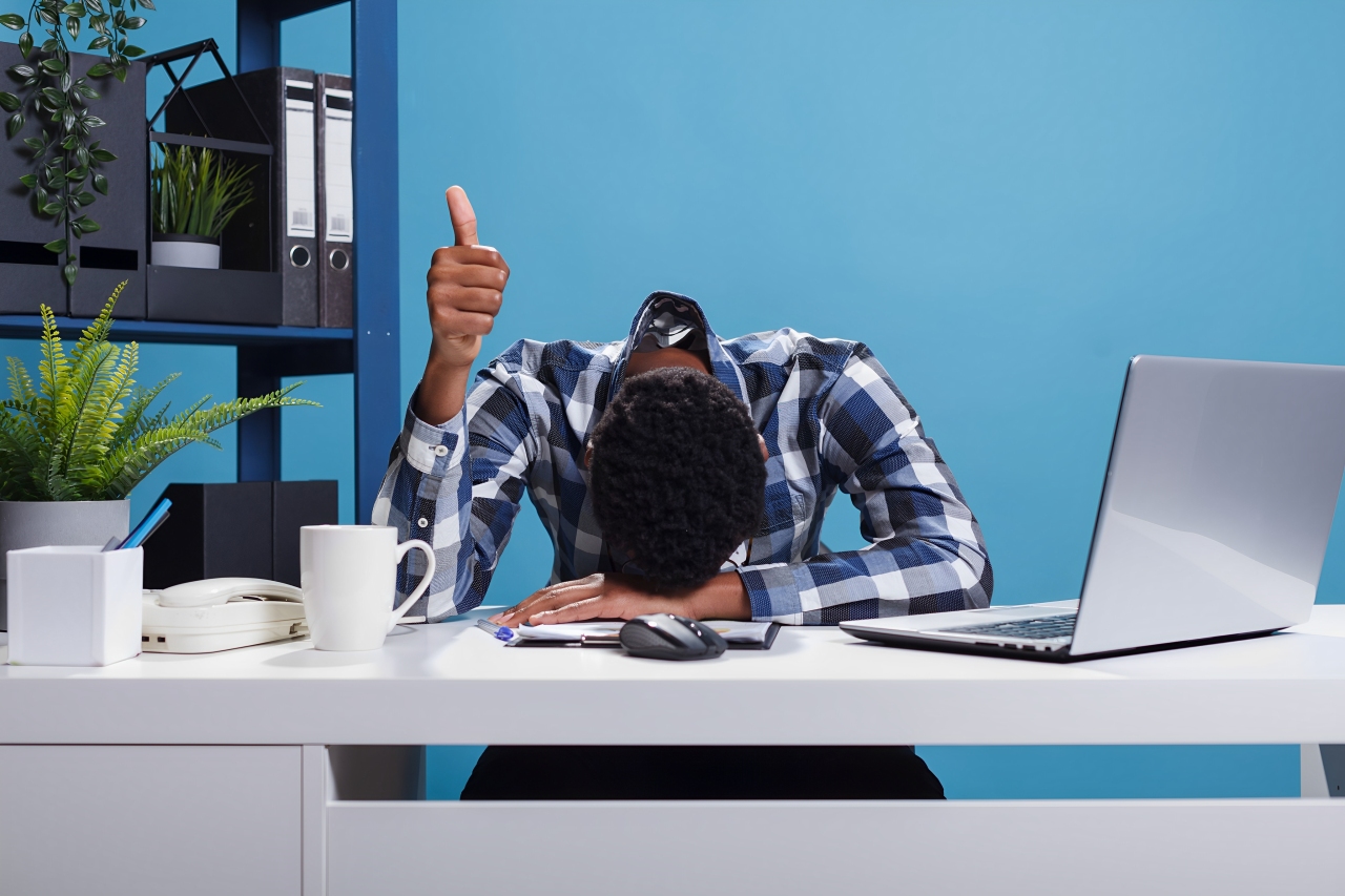 Extremely Fatigued Office Person Suffering From Burnout Syndrome Showing Thumbs Up Coworkers Doing Good Job Exhausted Businessman Falling Asleep Because Overwork While Showing Ok Symbol (1)